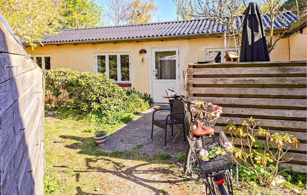 a house with a bike parked in front of it at Nice Home In Samsø With Wifi in Ballen