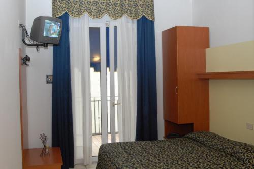 Posteľ alebo postele v izbe v ubytovaní Hotel Lido