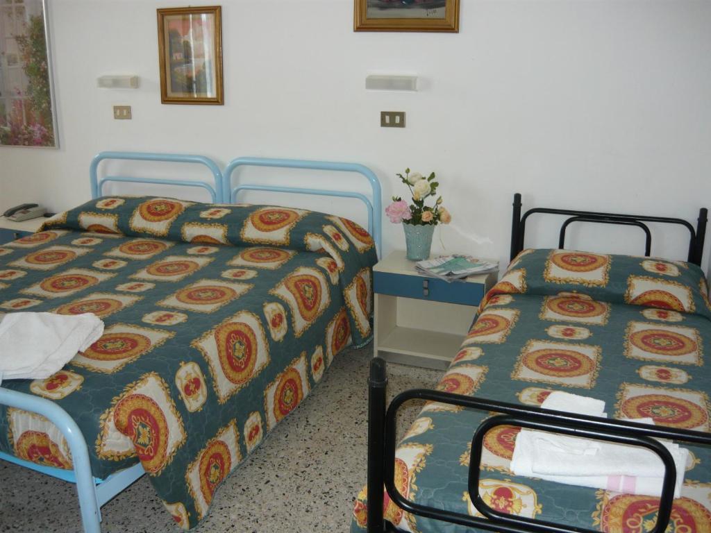 Postel nebo postele na pokoji v ubytování Hotel Acquazzurra