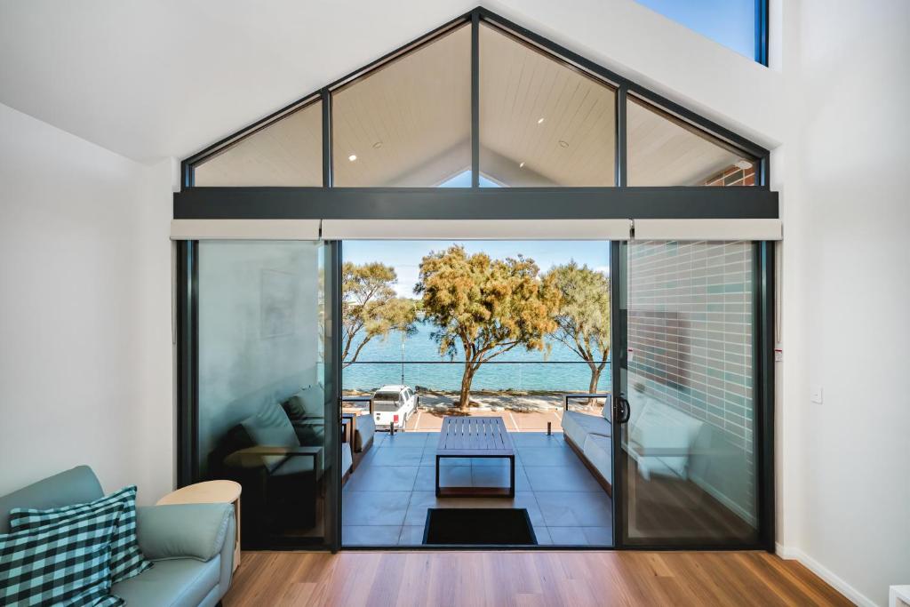 an open living room with a view of the ocean at Hello Dolphins Villas in Mandurah