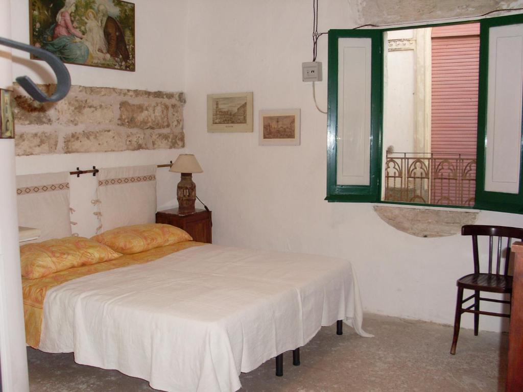 SoletoにあるBilocale San Nicolaのベッドルーム(ベッド1台、窓付)