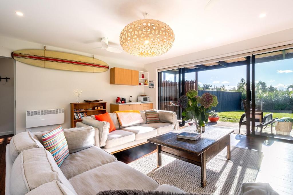 a living room with a couch and a table at Toi Toi Apartment in Martinborough