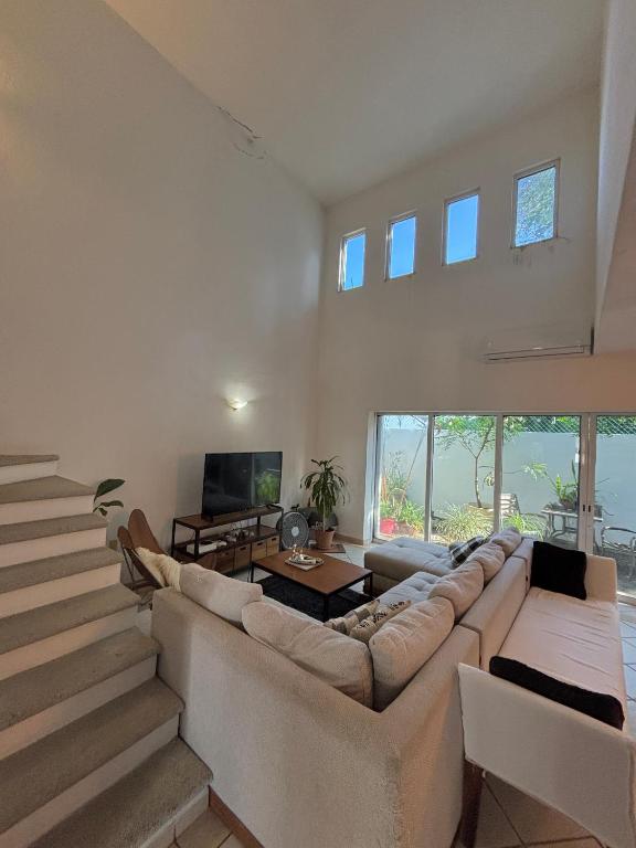 a living room with a large couch and a tv at Vacation Villa Marina in Puerto Vallarta