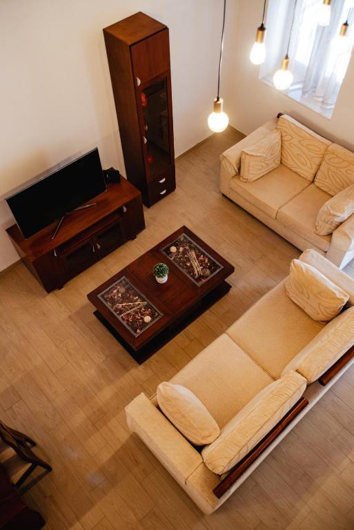 a living room with a couch and a coffee table at KOUL HOUSE in Lefkimmi