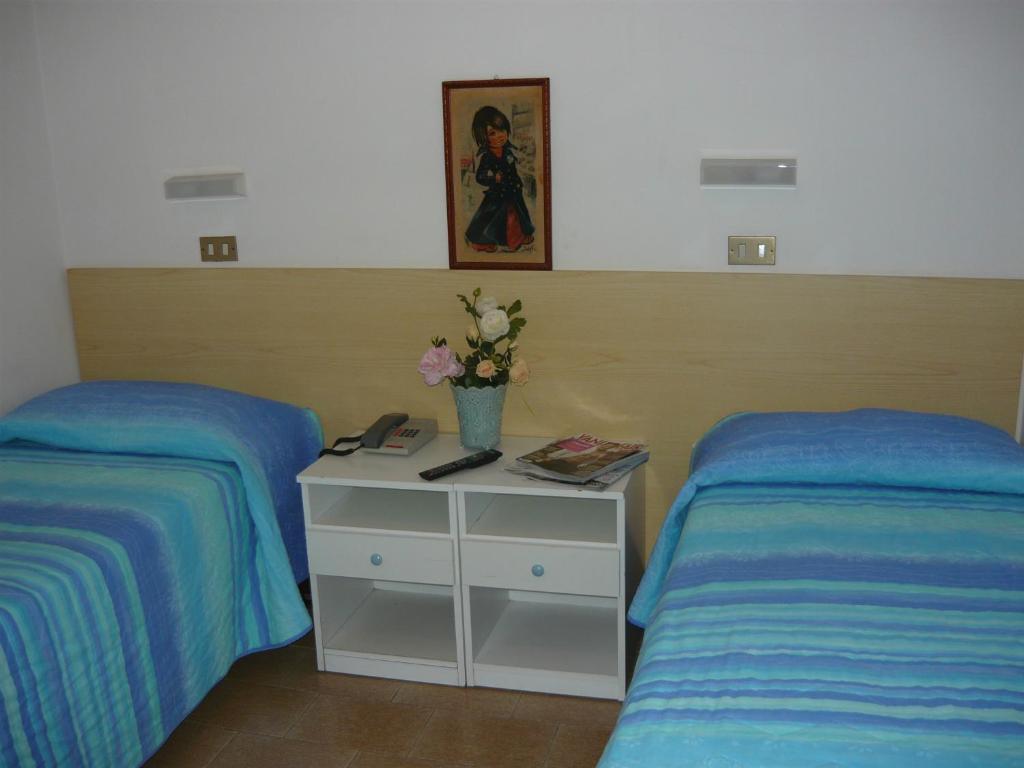 Postel nebo postele na pokoji v ubytování Hotel Acquazzurra