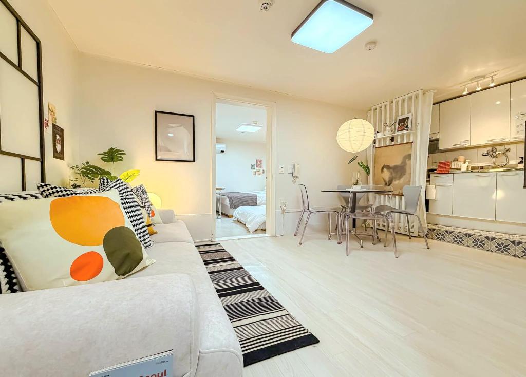 a living room with a white couch and a table at Hongdae 10 min Family 2BR Direct Airport Bus from ICN airport in Seoul