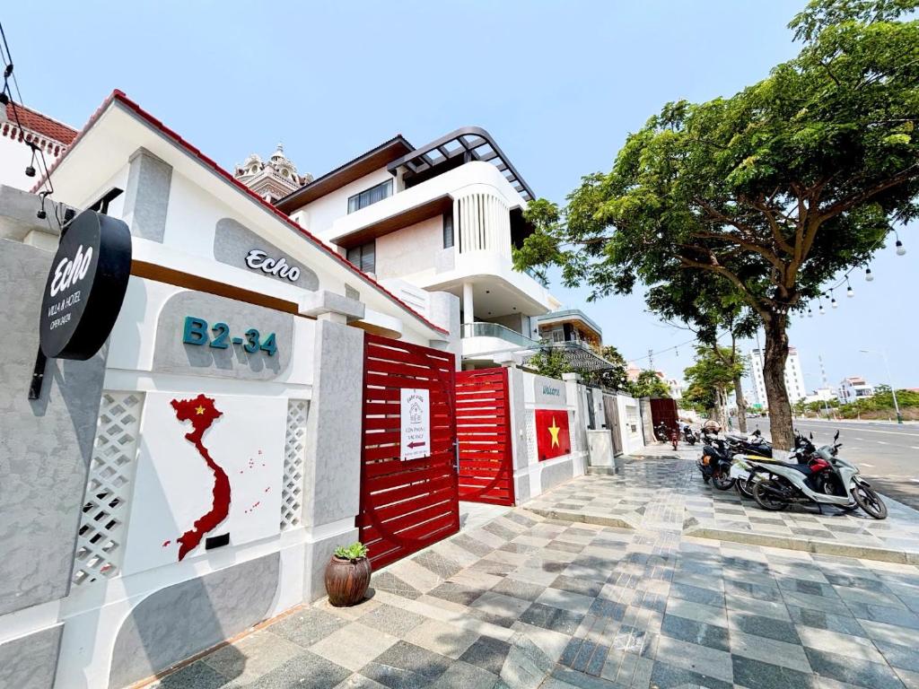 a building with red doors on the side of a street at ECHO VILLA PHAN THiET in Phan Thiet