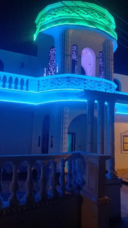 a building with blue lights on top of it at The white House in Aswan