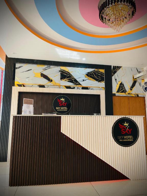 a room with a wall with two signs on it at Sky Hotel in Lucknow