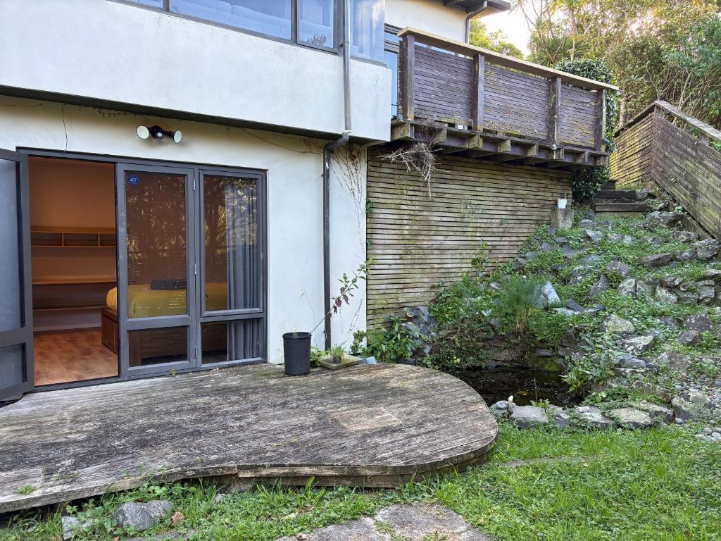 a house with a wooden porch and a balcony at Ke's home in Wellington