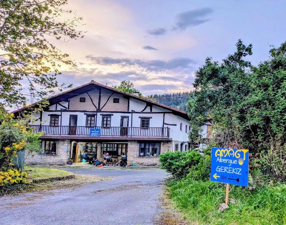 a large white building with a sign in front of it at Albergue Gerekiz AMAGI, exclusivo peregrinos in Flores
