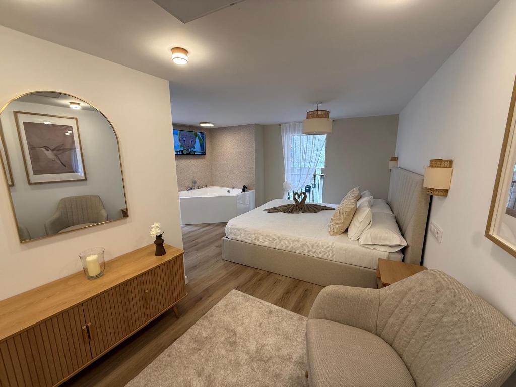 a bedroom with a bed and a mirror and a couch at El Rincón de Mateo in Combarro