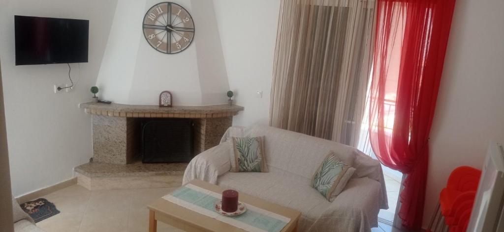 a living room with a couch and a fireplace at Sofia Comfort Apartment in Nivicë