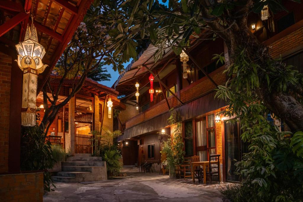 a courtyard of a building at night with lights at Boutique House Nipha in Chiang Mai