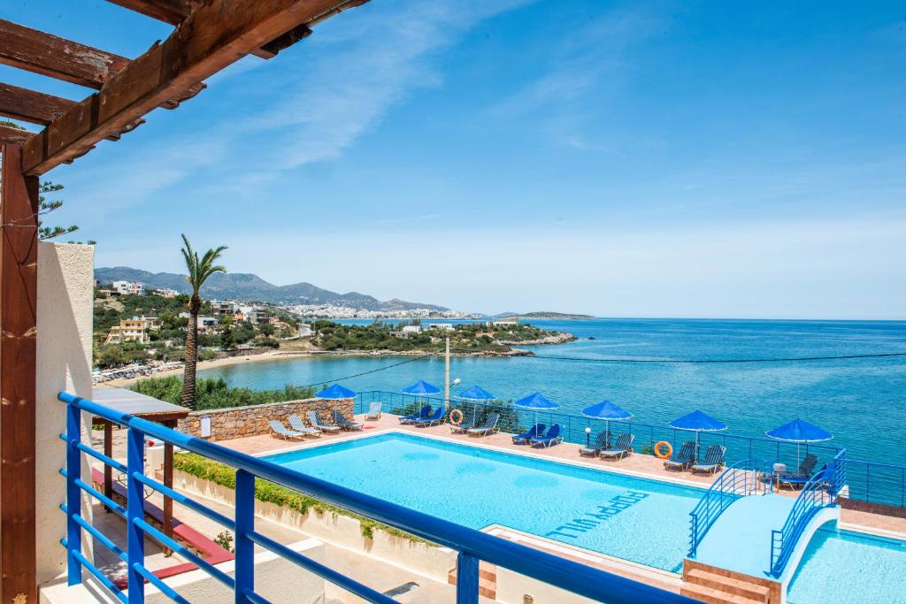 a view of a swimming pool and the ocean at Poppy Villas in Agios Nikolaos