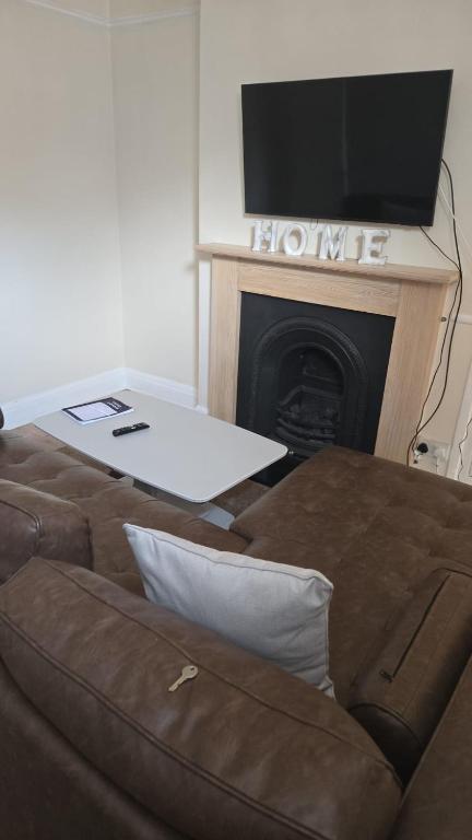 a living room with a couch and a flat screen tv at Balfour house III in Leicester