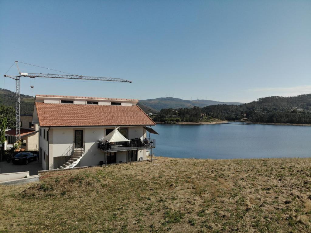 a house with a view of a lake at Casa do Ferreiro T2 in Montalegre
