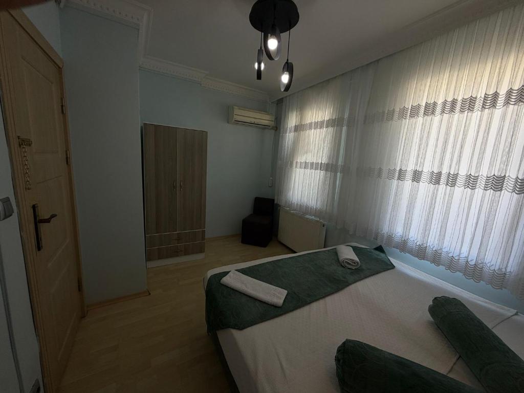 a bedroom with a large bed and a window at Ramonun Yeri in Istanbul