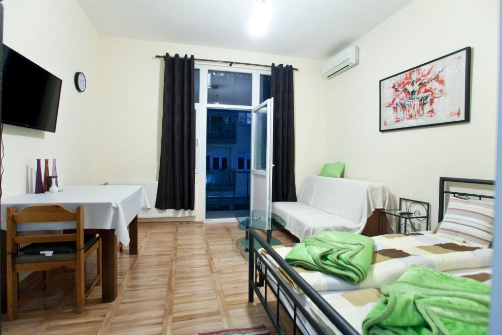a living room with two beds and a table at Hostel 1910 in Belgrade