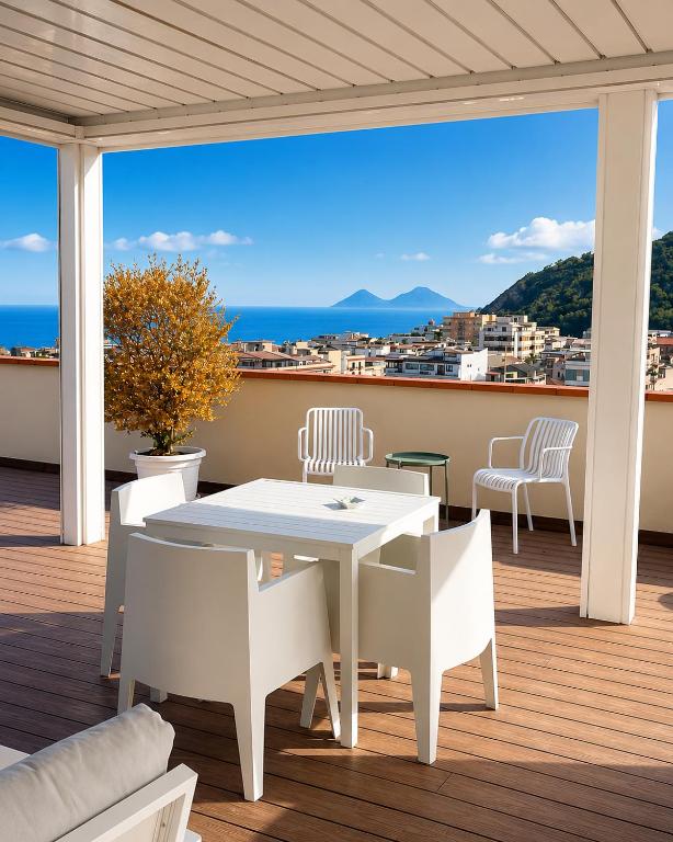 a white table and chairs on a balcony with a view at B&B Del Corso in Capo dʼOrlando