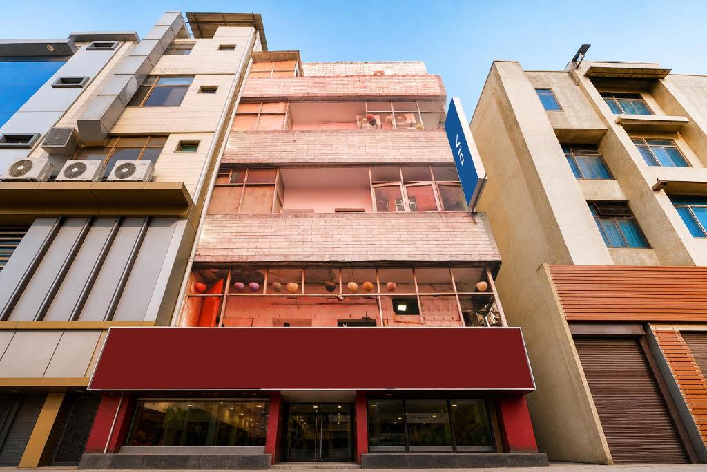 a tall building with a red awning at Via The Akshardham Bliss - LAXMI NAGAR METRO in New Delhi