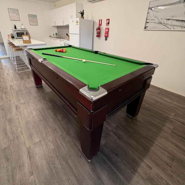 a pool table in a room with a green cloth at Roantree House in Portland