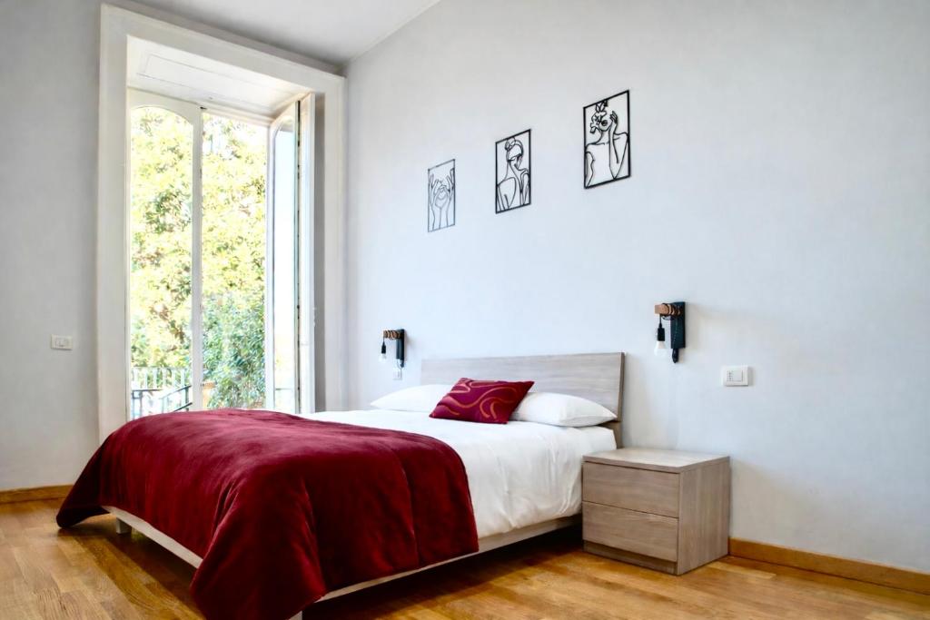 a white bedroom with a large bed and a window at Royal Palace B&B in Caserta