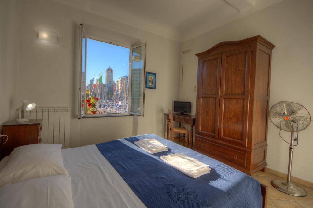 a bedroom with a large bed and a window at Club Nautico Savona in Savona