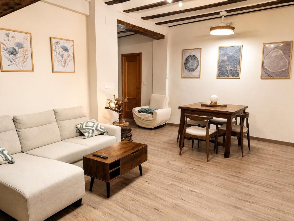 a living room with a couch and a table at Casa río de Bolbaite in Bolbaite