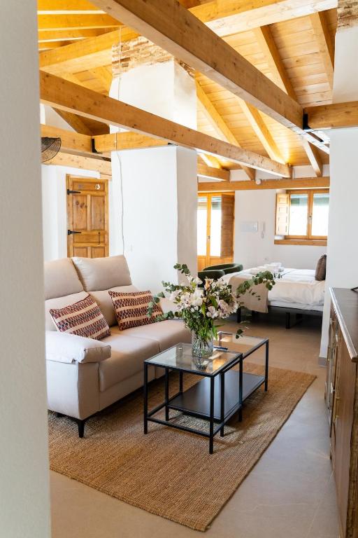 a living room with a couch and a table at Casa Molivez Apartamento Fabregas in Alhama de Granada