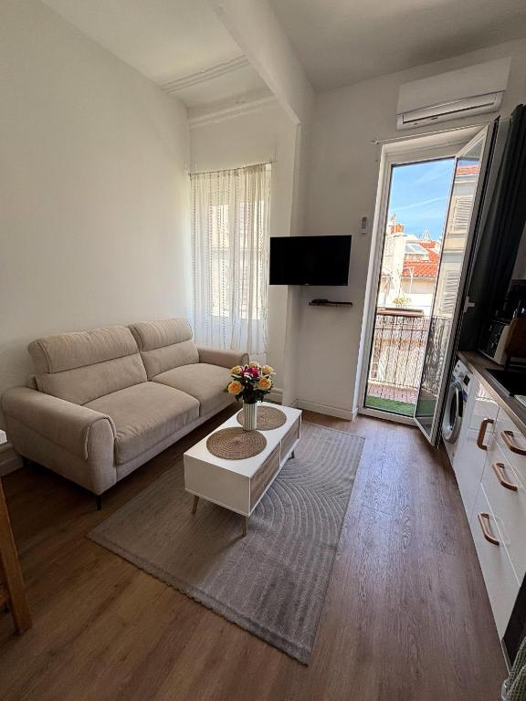 a living room with a couch and a table at Apartment in Noailles Marseille in Marseille