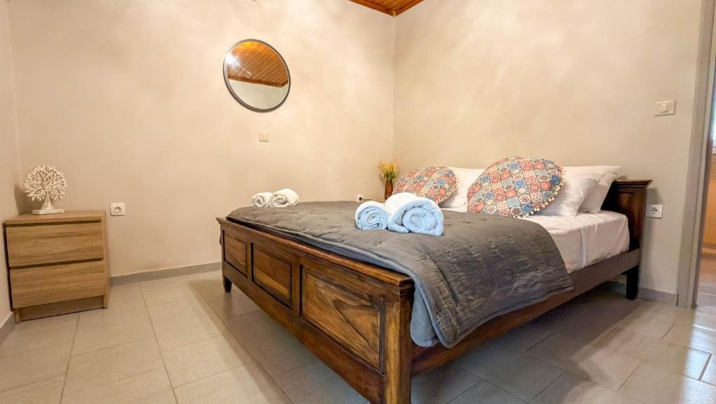 a bedroom with a bed with towels and a mirror at Zografia View in Corfu