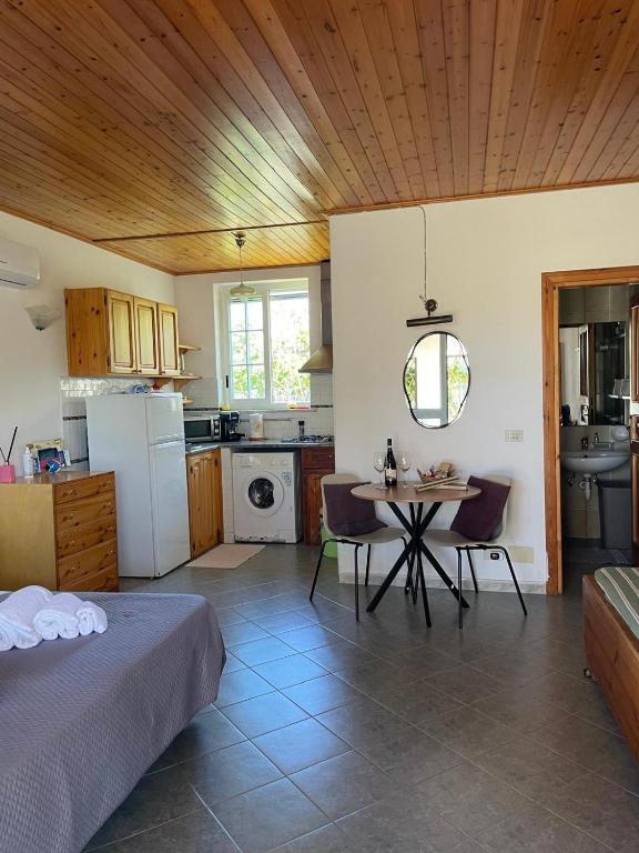 a kitchen with a bed and a table in a room at casa l'olivo in Forio d'Ischia
