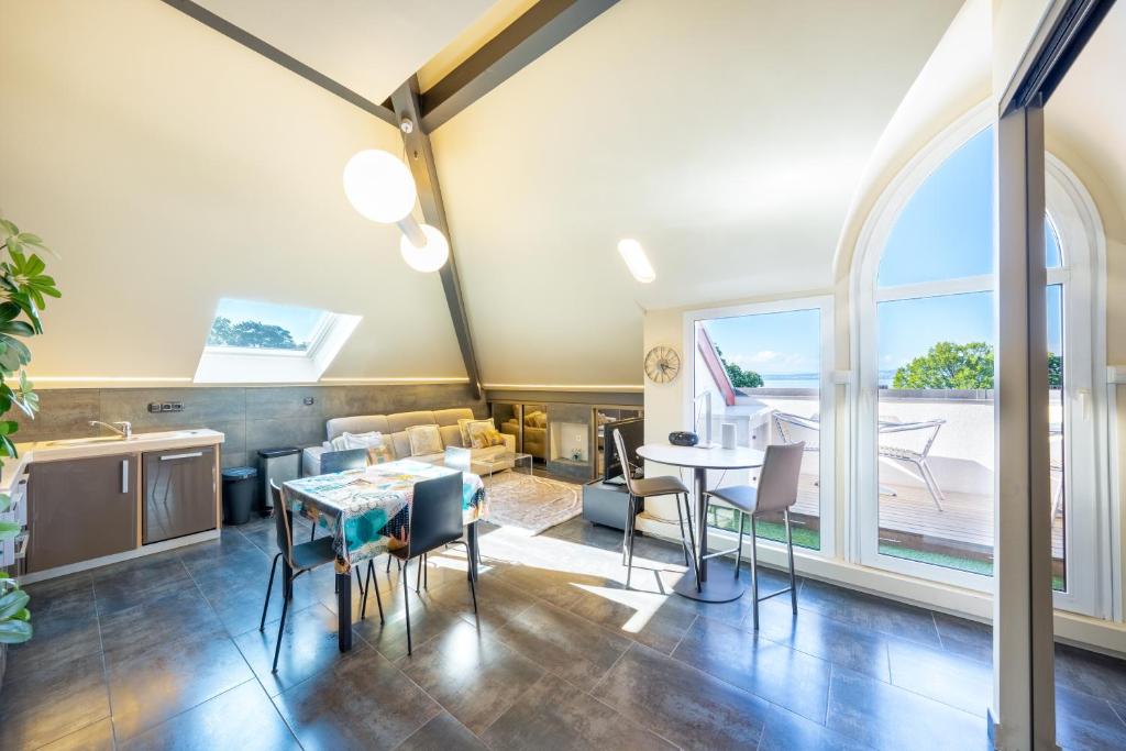 a living room with a table and chairs at Le Princess in Évian-les-Bains