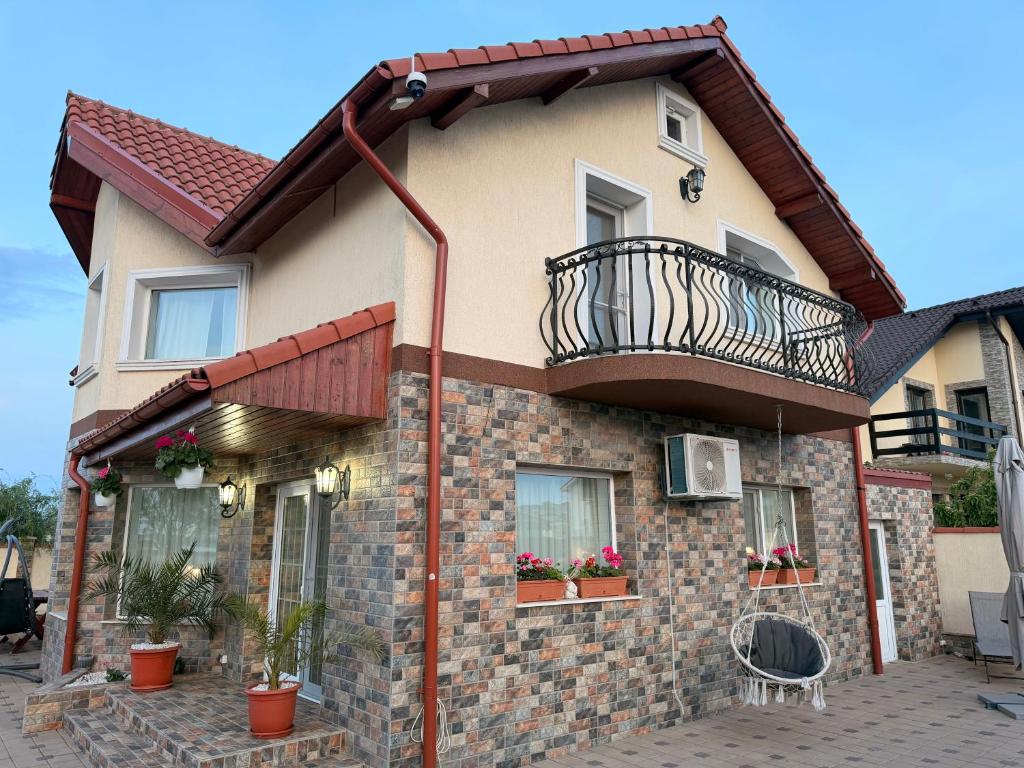 a brick house with a balcony on top of it at Nistor House-Delta Retreat in Tulcea
