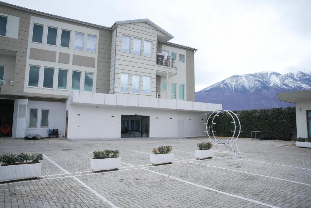 a building with some potted plants in front of it at Hotel haliti kukes in Kukës