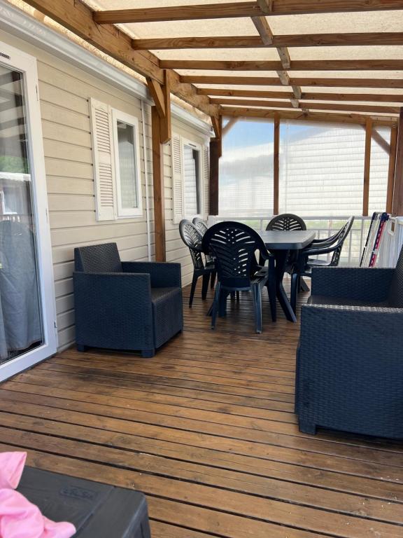 a patio with a table and chairs on a deck at Mobilehome in Vias