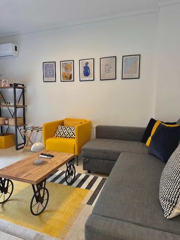 a living room with a couch and a table at Blue Cozy Nest in Rhodes Town