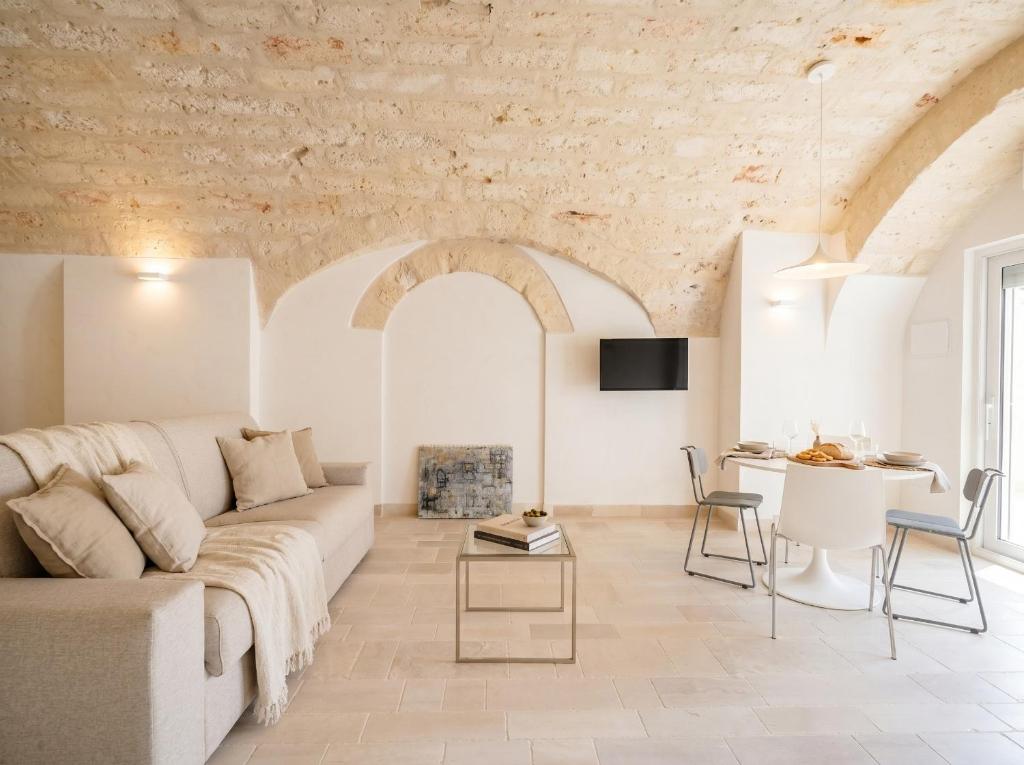 a living room with a couch and a table at Palazzo Della Tore 001-Elegant Historic Escape in Torre a Mare