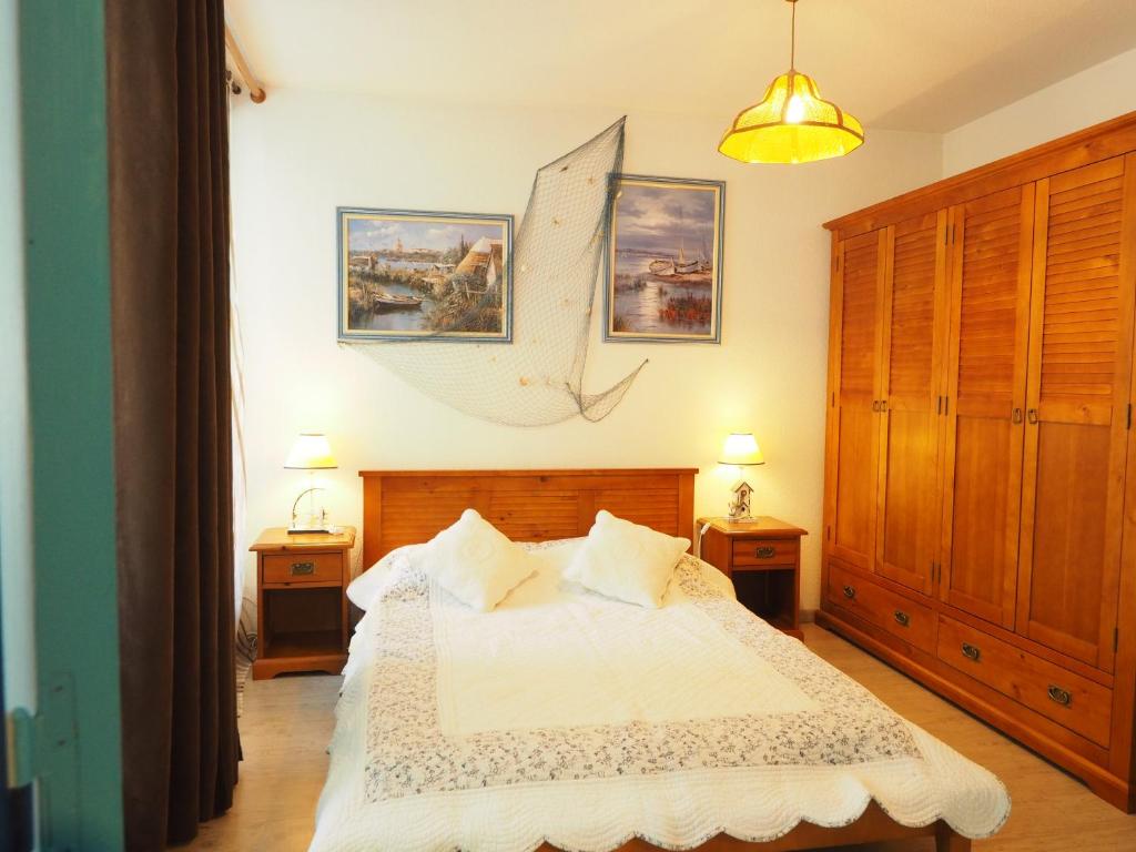 a bedroom with a bed with two night stands and two lamps at Bel appart vue lac in La Grande Motte