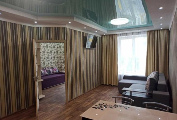 a living room with a couch and a table at ЖК Хмельницький in Dnipro
