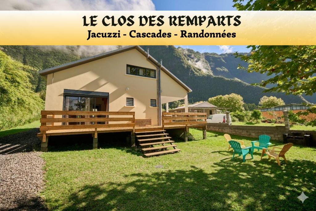 a small house with a deck and chairs in the yard at Le Clos des Remparts - 8 pers - Cascades & Nature in La Plaine des Palmistes