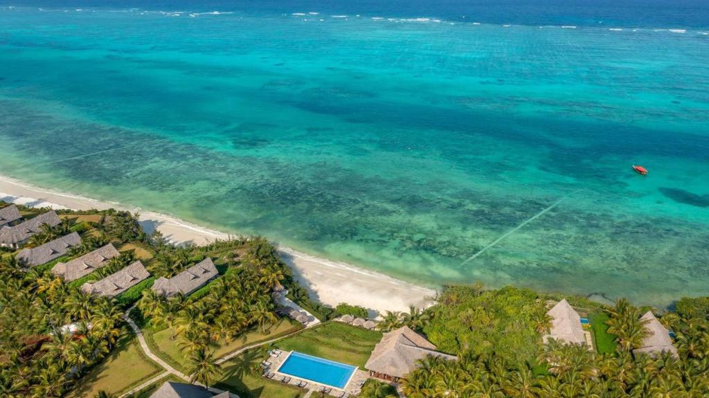 an aerial view of a beach with houses and the ocean at Zawadi Hotel, Zanzibar in Michamvi