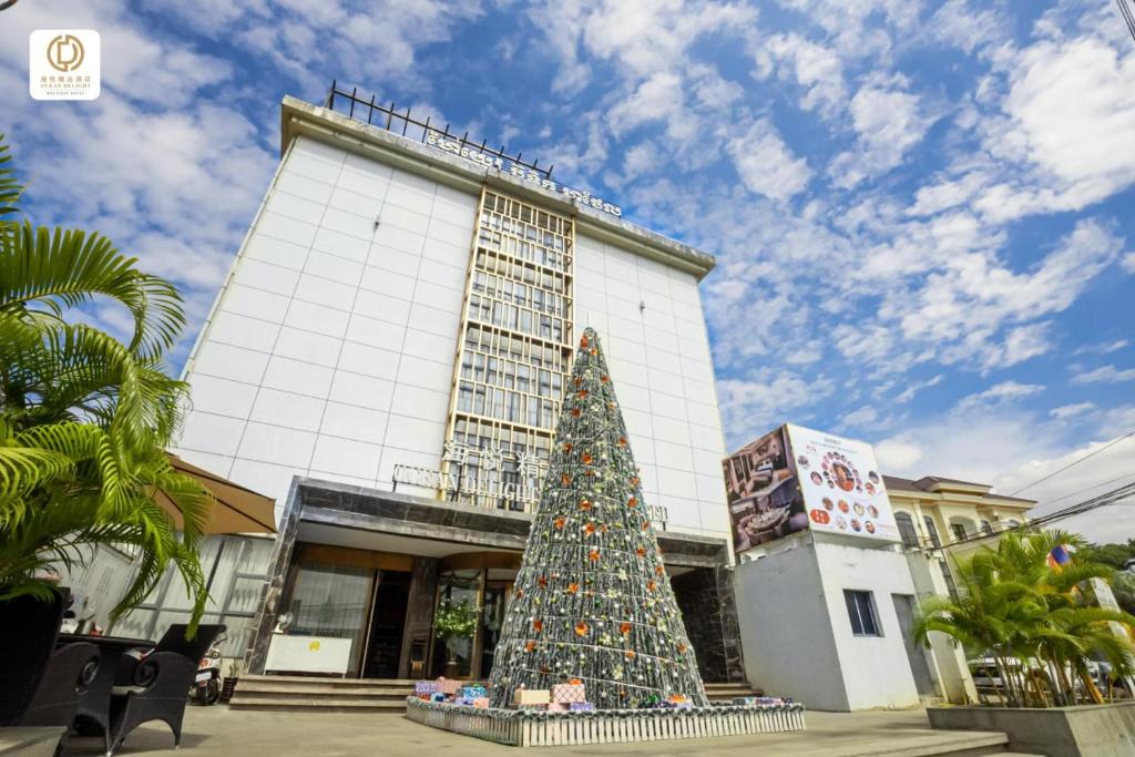 a christmas tree in front of a building at Ocean Delight Boutique Hotel 海悦精品酒店 in Sihanoukville