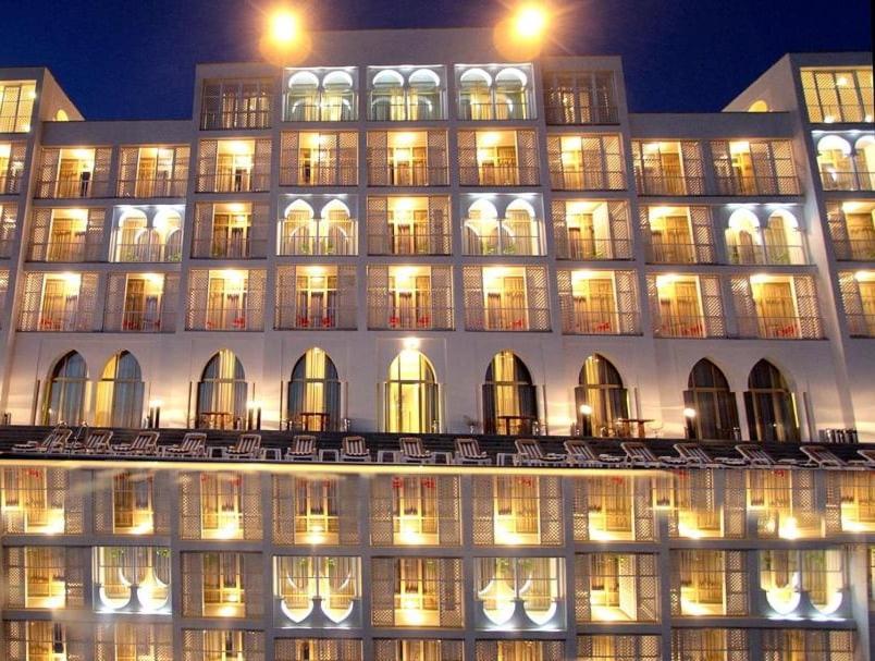 a lit up building with chairs in front of it at Hotel Anaklia in Zugdidi