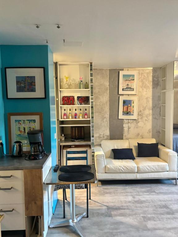 a living room with a white couch and a table at Central Studio - Port & Lices walkable - Parking in Saint-Tropez