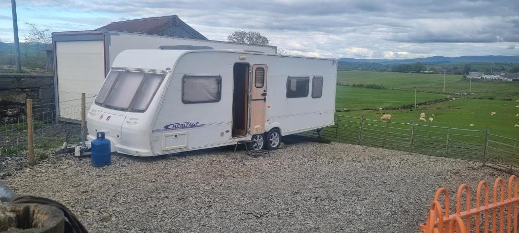 a white trailer parked next to a fence at Peaceful Private Haven in Frongoch