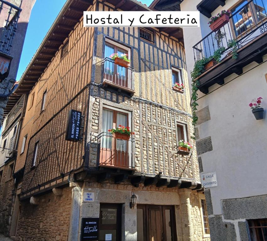 an old building with flower boxes on the windows at Hostal El Rincón del Trillo in La Alberca