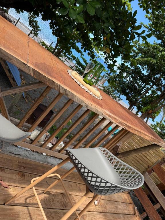 a chair and a surfboard on top of a roof at Kay Yvette in Saint-Pierre