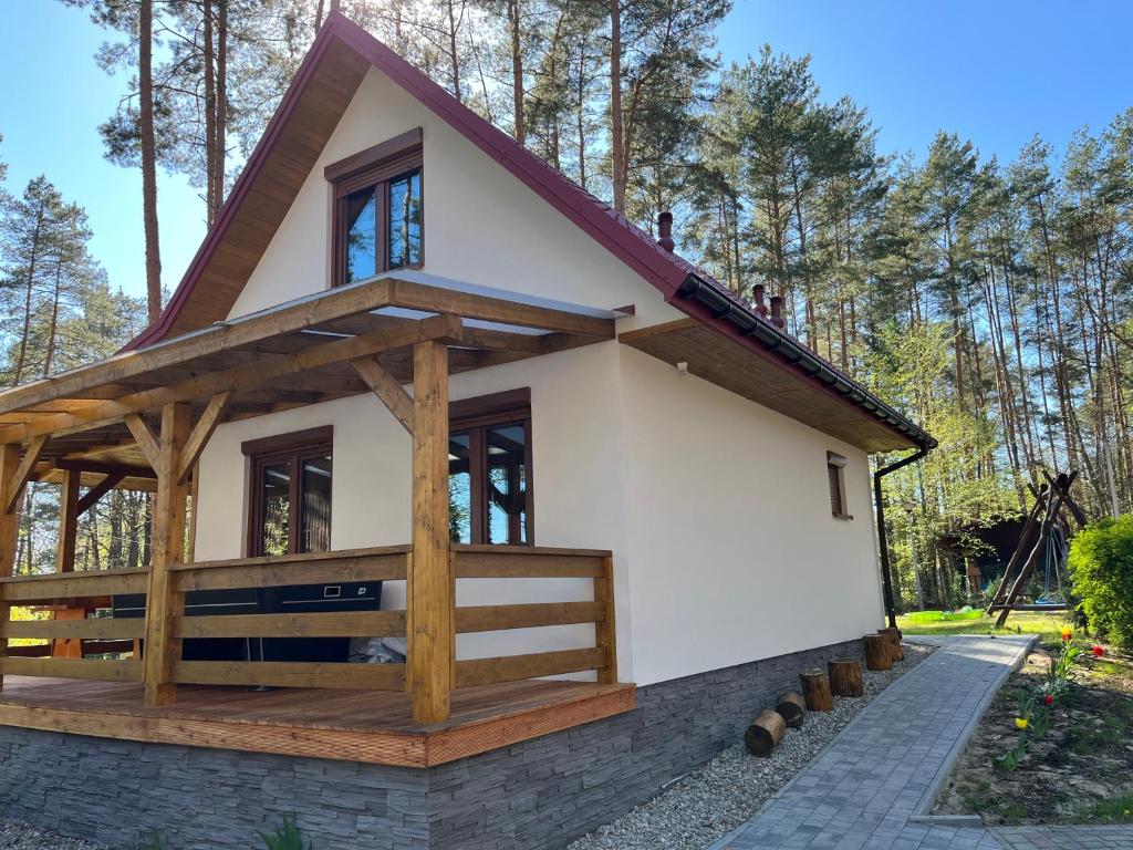 a small house with a gambrel roof at Leśna Oaza Radawa in Radawa